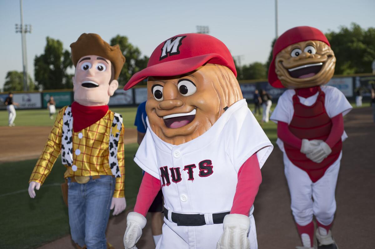 Modesto Nuts mascots walk on the field before a game at John Thurman Field in Modesto in 2018.