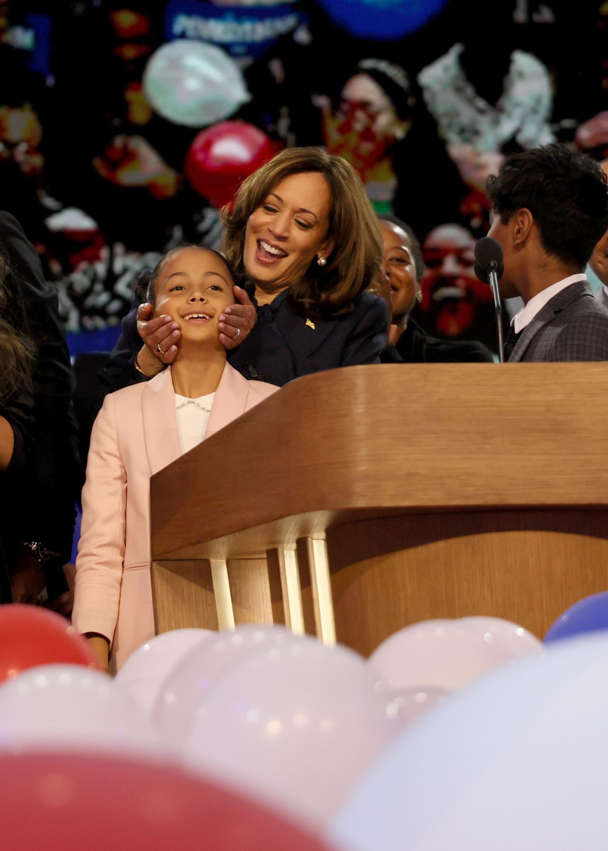 Kamala Harris cradles the face of grandniece Amara Ajagu at the DNC