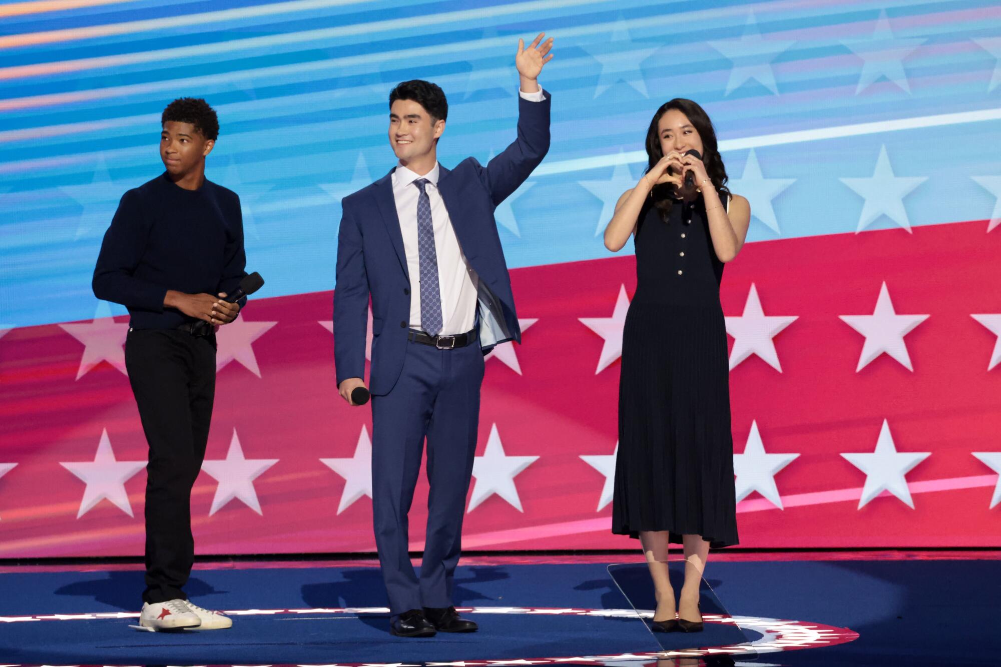 Alexander Hudlin, left, Jasper Emhoff and Arden Emhoff onstage at the DNC