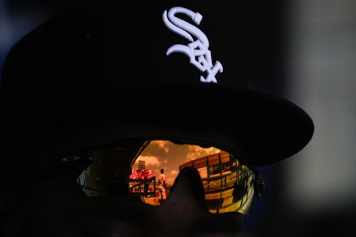 Chicago White Sox first base coach/outfield coach Jason Bourgeois is reflected in sunglasses.