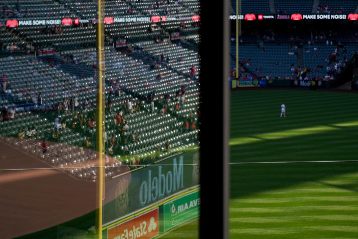 Empty seats reflected above a baseball field