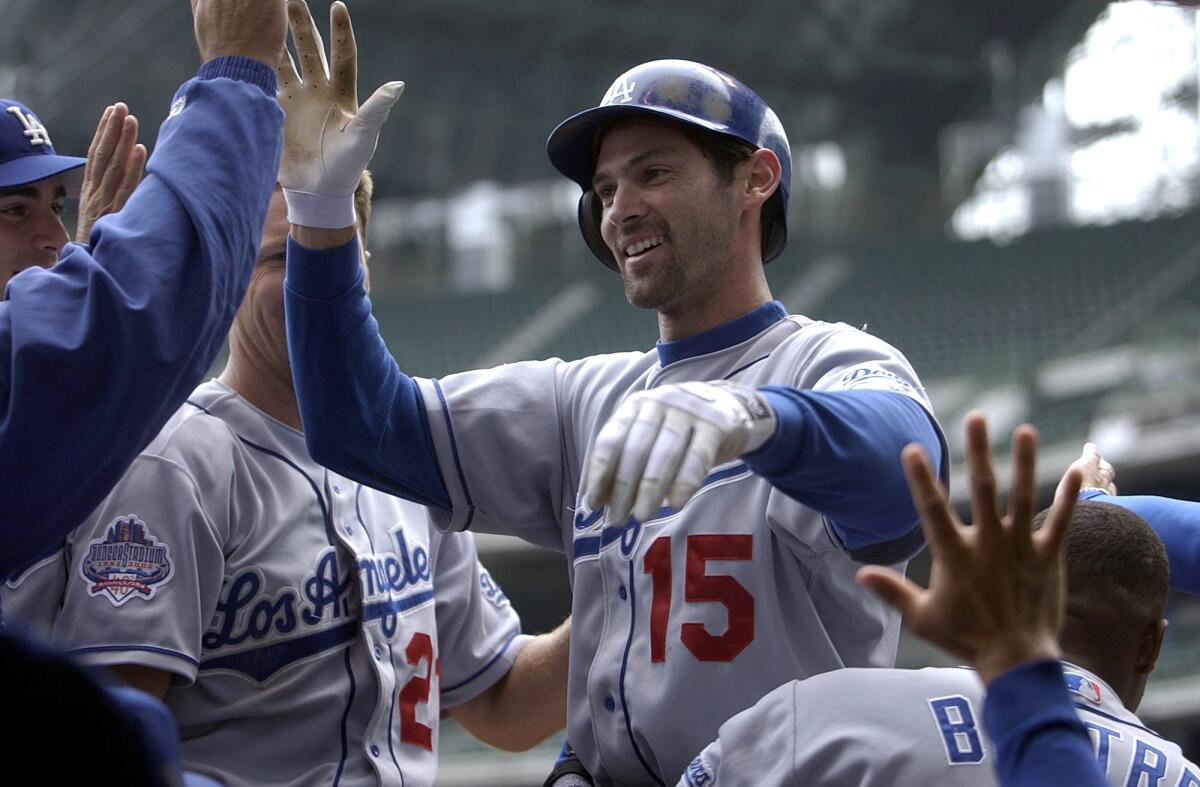 Shawn Green greets teammates in the dugout after hitting his fourth home run during a win over Milwaukee on May 23, 2002.