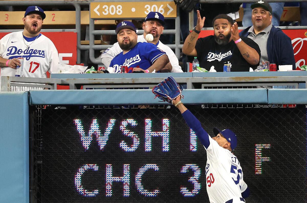 Dodgers right fielder Mookie Betts makes a catch at the wall during the first inning Friday against the Colorado Rockies.