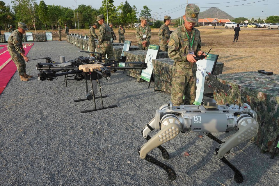 Members of the Chinese Army train with a robot dog, complete with machine gun attachment