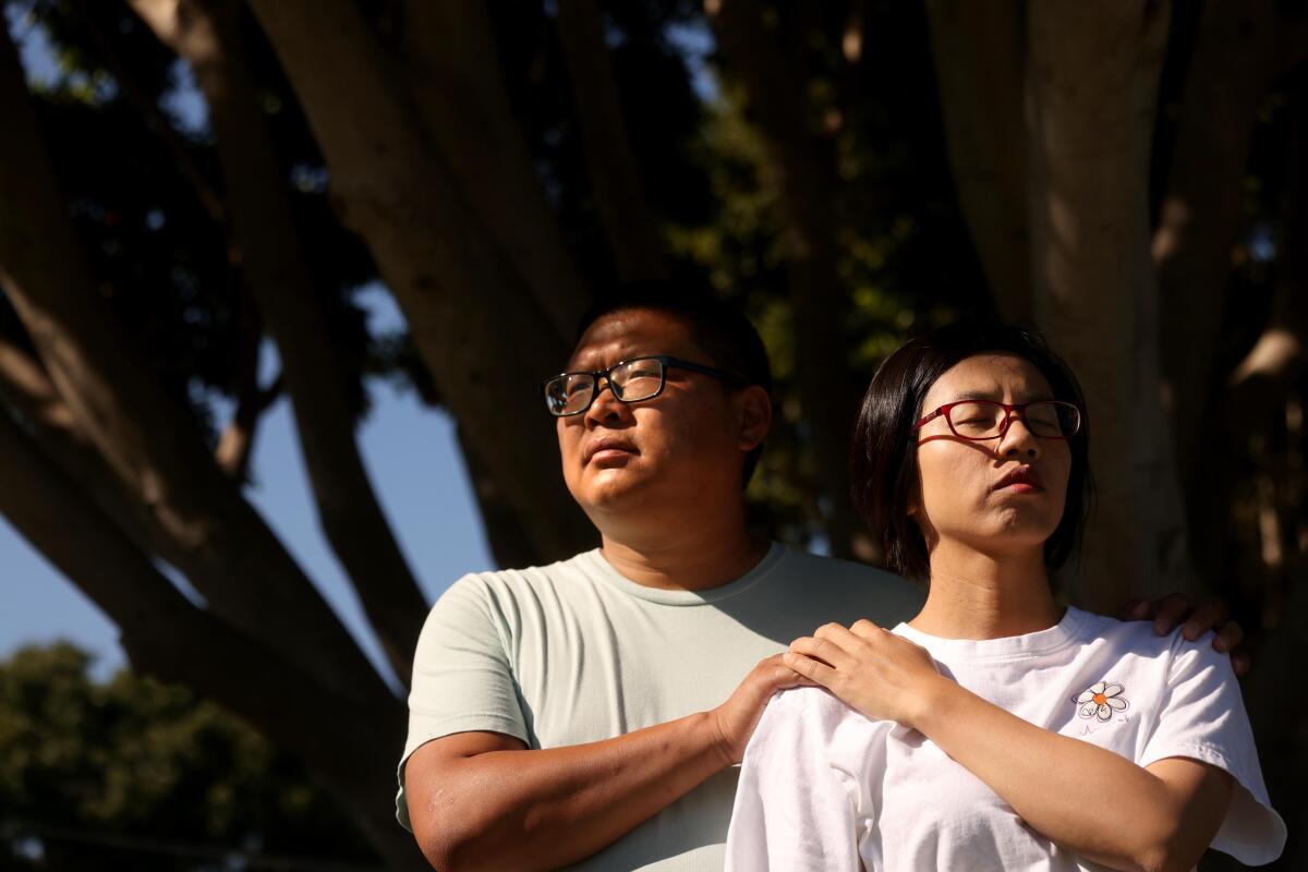 Tingbo Cao, left, and his wife Qilian Zhou thought they would receive a tuition-free education at Olivet University.