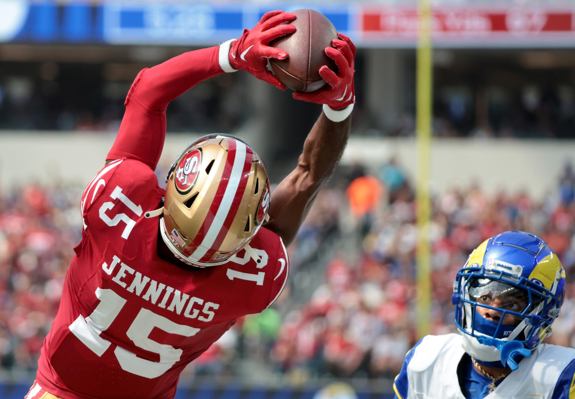 San Francisco 49ers wide receiver Jauan Jennings makes a catch in front of Rams cornerback Cobie Durant.