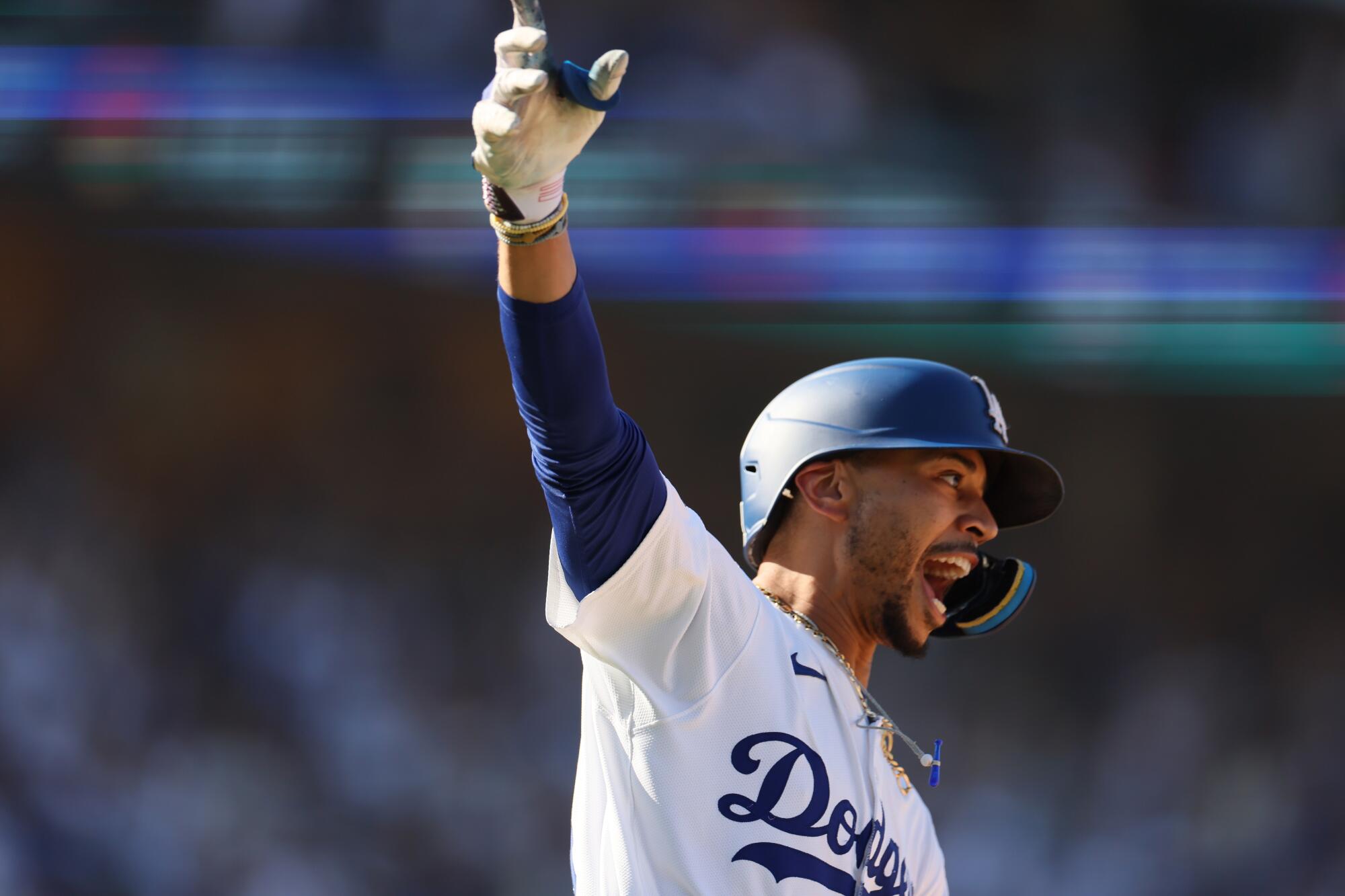 Mookie Betts celebrates his walkoff home run in the ninth inning against Colorado on Sunday.