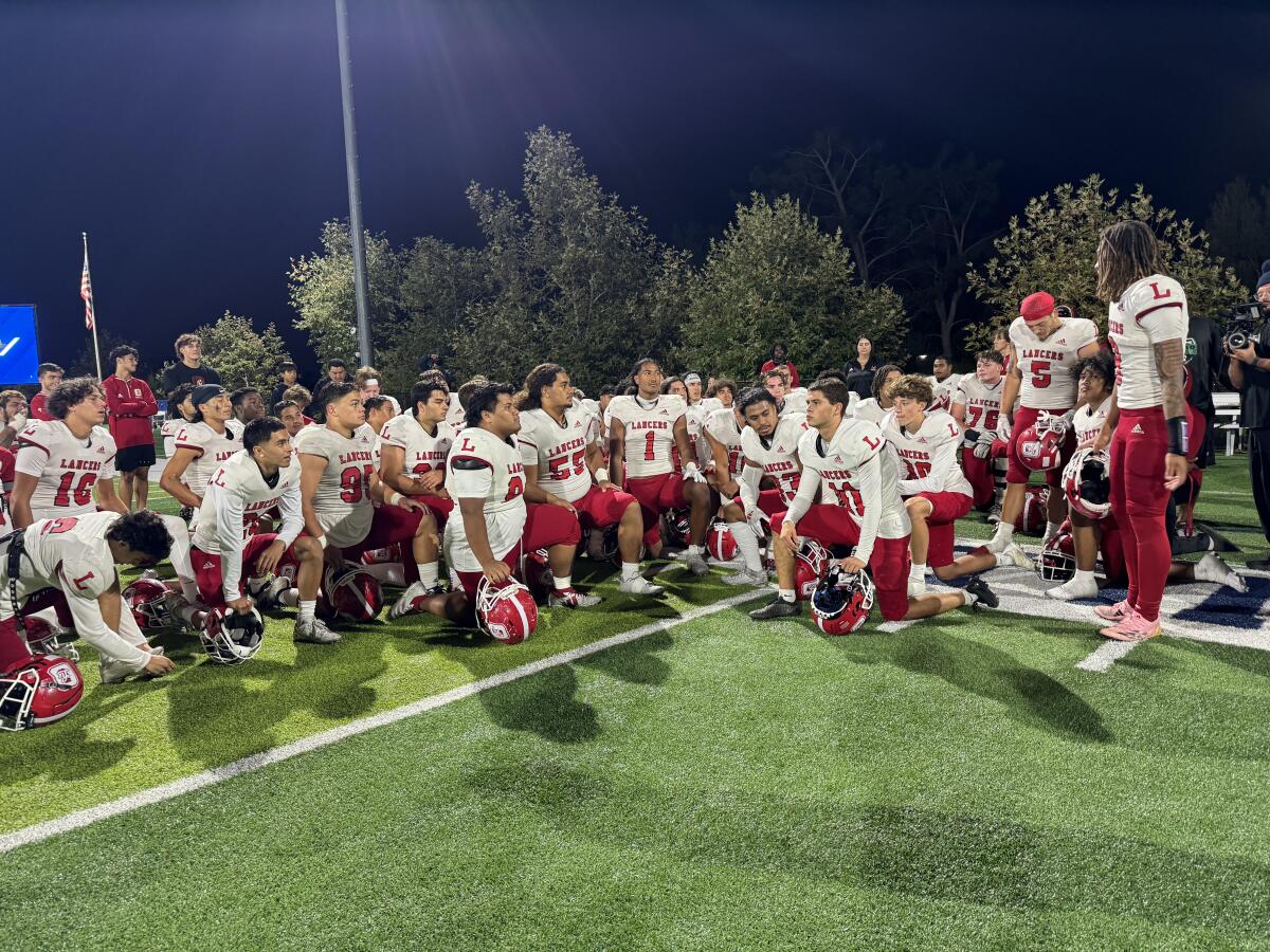 Orange Lutheran players gather after overcoming a 26-7 halftime deficit to beat Sierra Canyon 33-26.