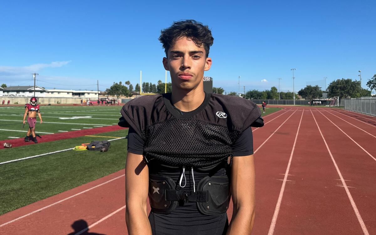 Downey High junior quarterback Oscar Rios poses for a photo during practice.