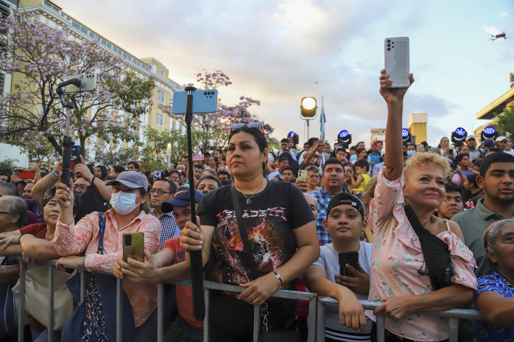 Supporters wait for El Salvador's President Nayib Bukele outside the National Theater in San Salvador, El Salvador.