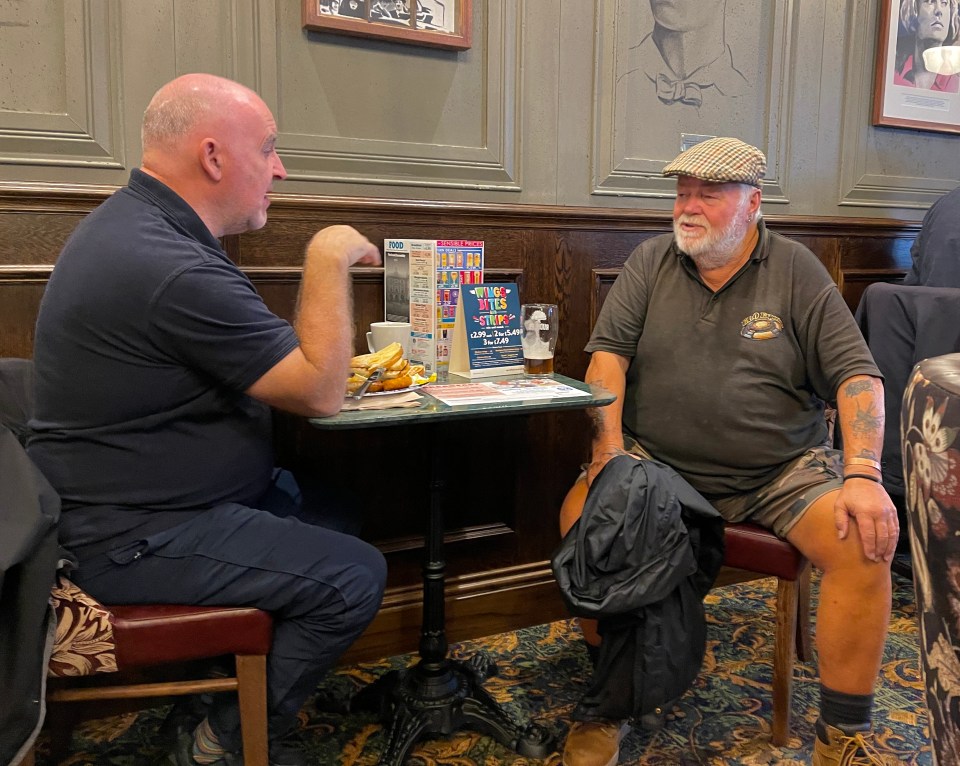 Two pals enjoy a meal and a pint