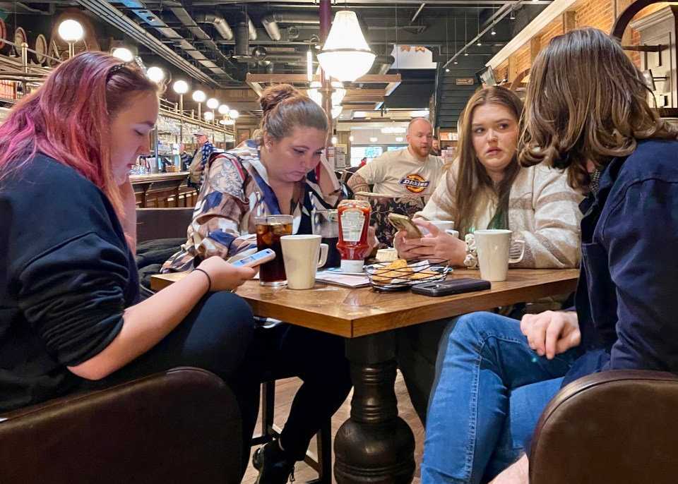 A group of young women wait for their food