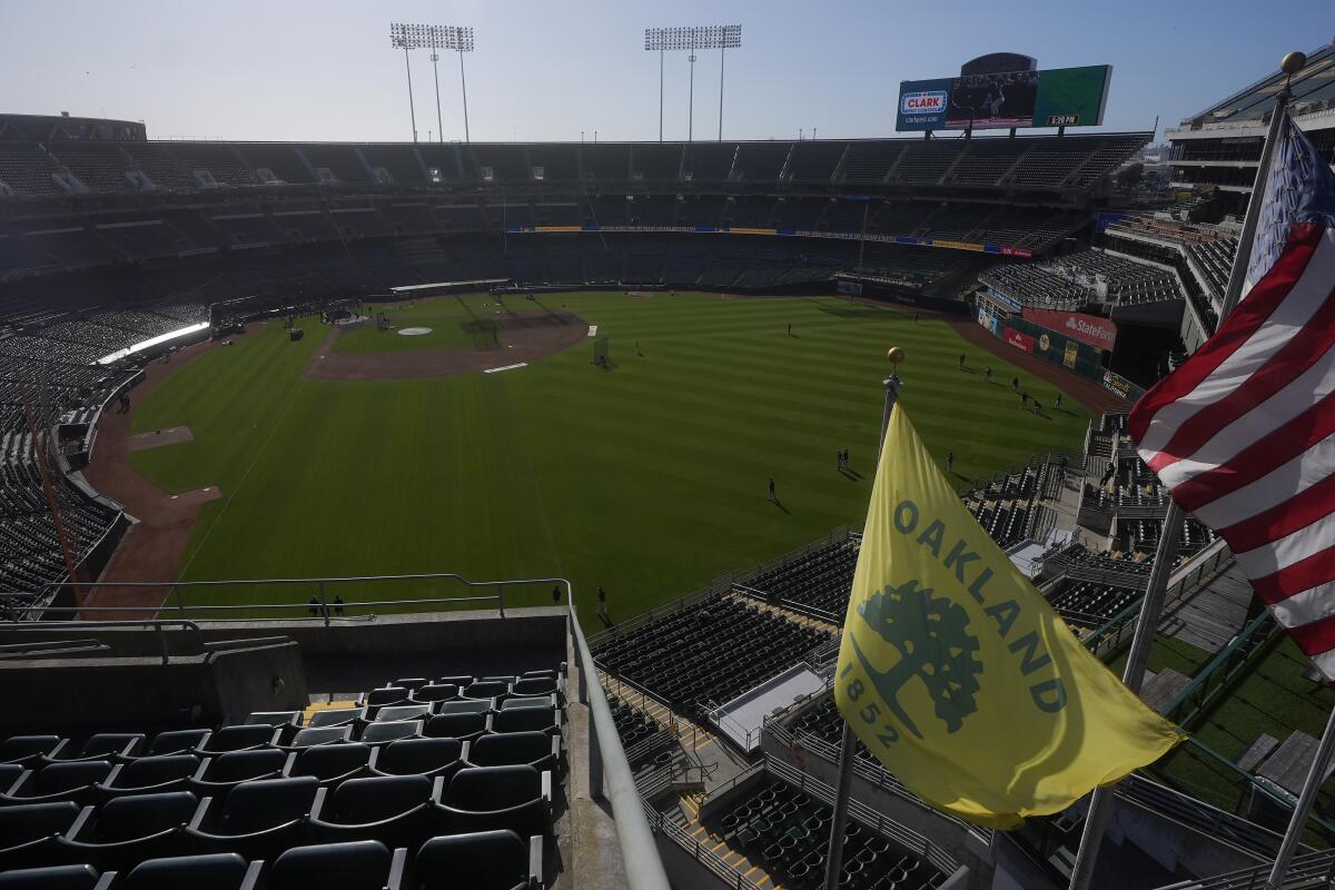 A city of Oakland flag flies at Oakland Alameda Coliseum before a game between the Athletics and the Rockies.