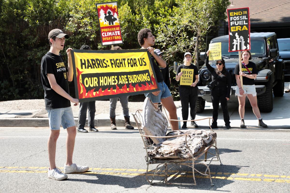 Sunrise Movement activists slow traffic outside Vice President Kamala Harris' home in Brentwood on Monday.