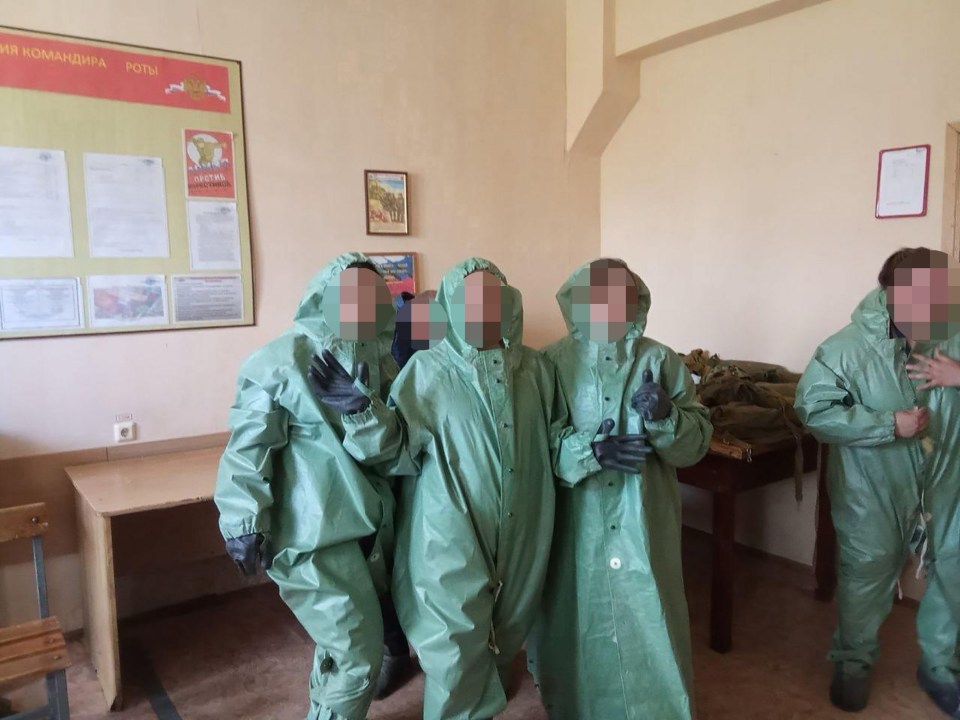 The children posing in their hazmat gear