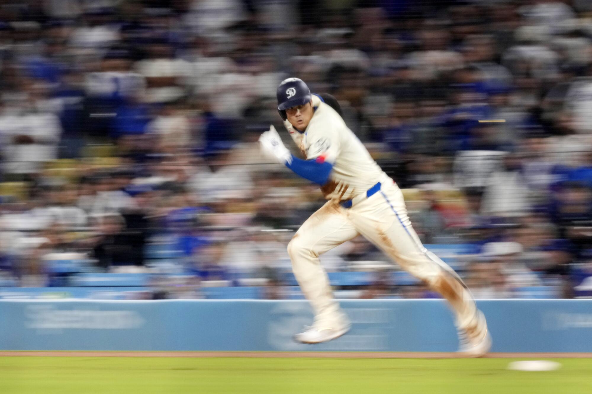 The Dodgers' Shohei Ohtani steals second base during a game against the Rockies on Saturday.