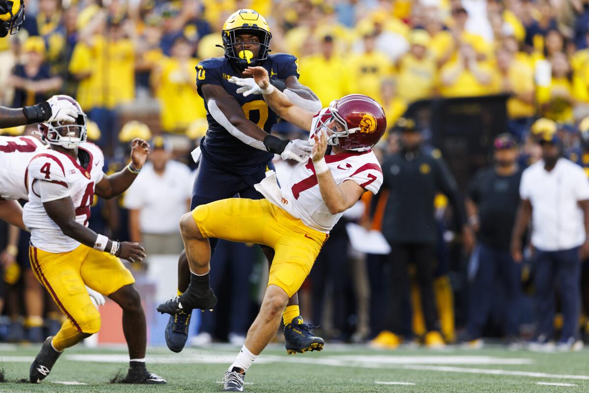 Michigan's Josaiah Stewart knocks down USC quarterback Miller Moss during the Trojans' loss at Michigan Stadium