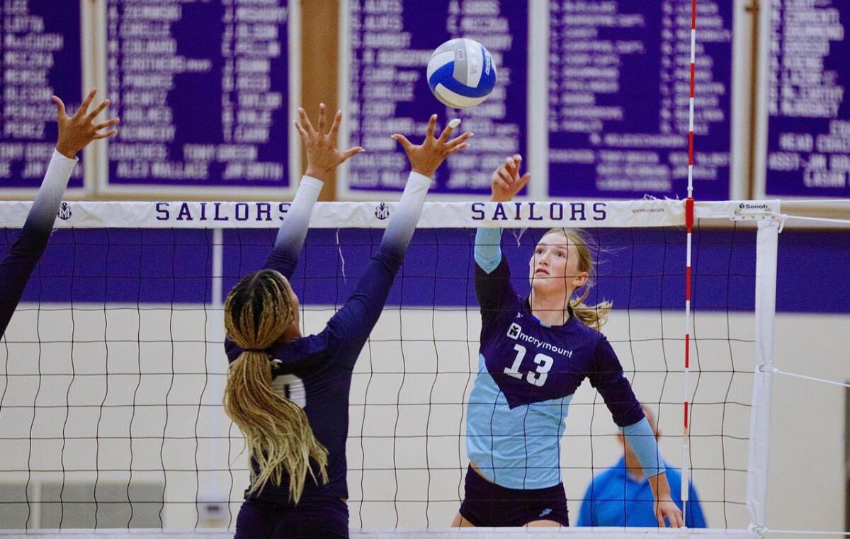 Marymount hitter Makenna Barnes tips the ball over Sierra Canyon blocker Davan Antoine-Dillon in the fifth set.