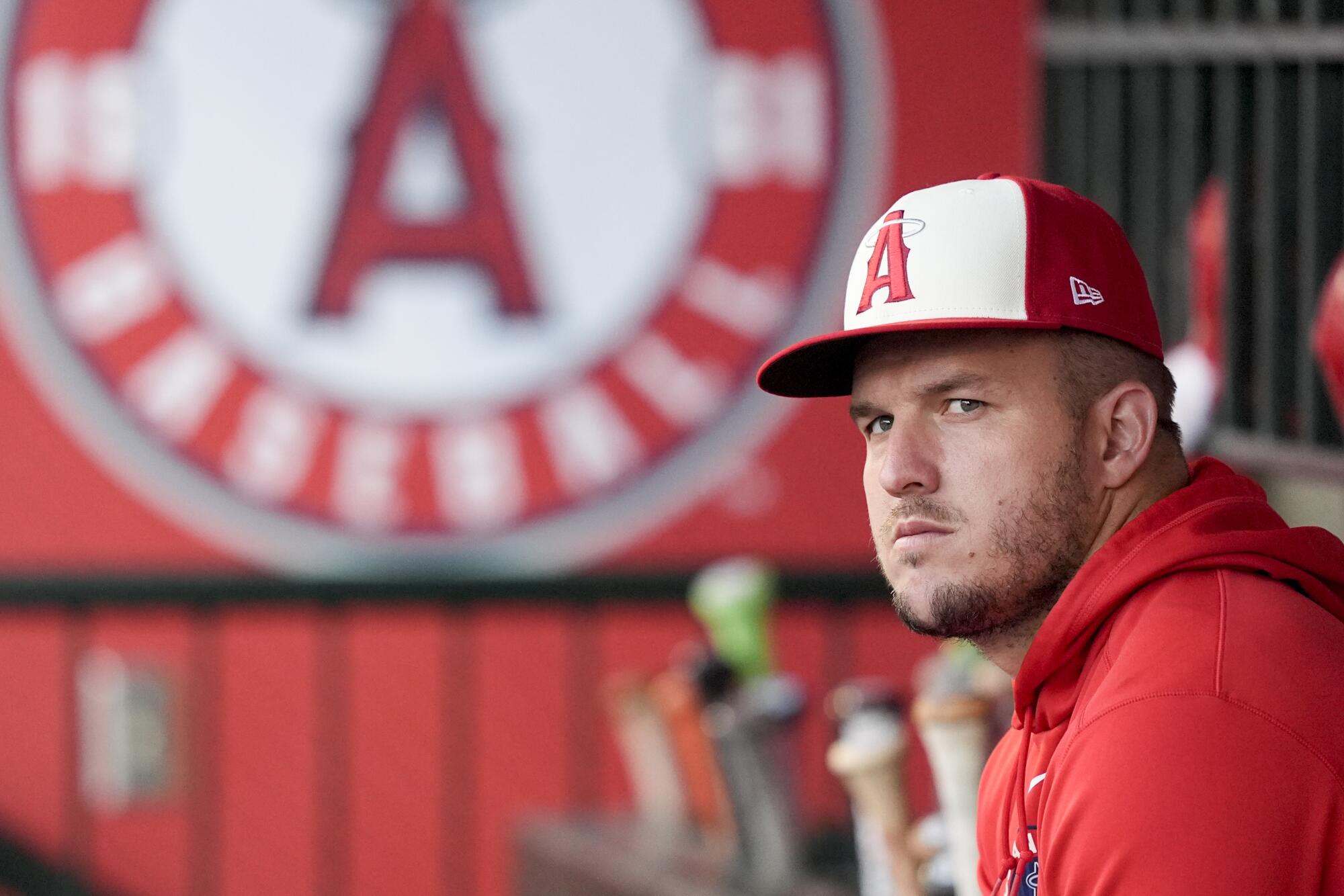 Angels center fielder Mike Trout sits in the dugout during a game against the Mets on Aug. 2 at Angel Stadium.