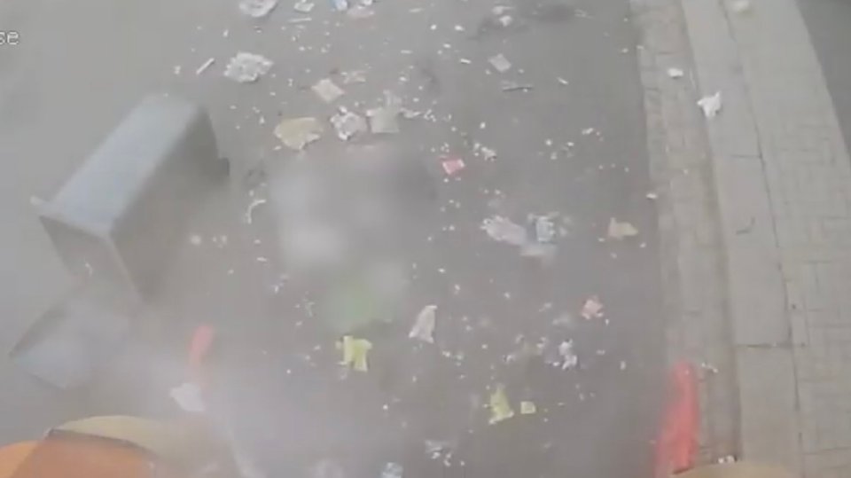 When the smoke clears, rubbish can be seen scattered all over the road in North London