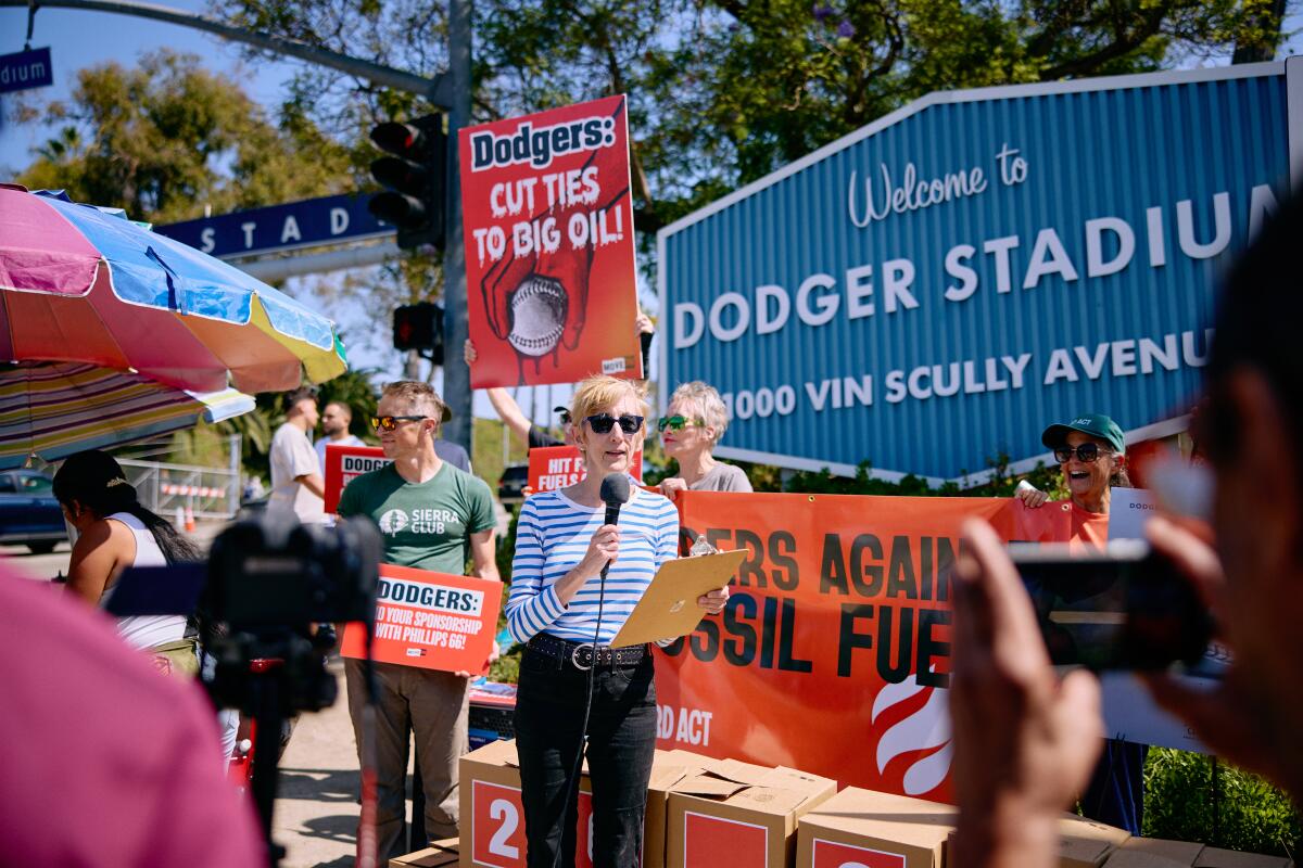 Climate activists protest outside Dodger Stadium on Sept. 22, calling on the Dodgers to stop running ads from Phillips 66.