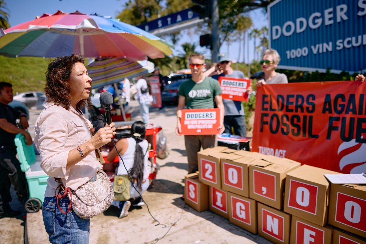 Community organizer Alicia Rivera speaks at a rally outside Dodger Stadium on Sept. 22.