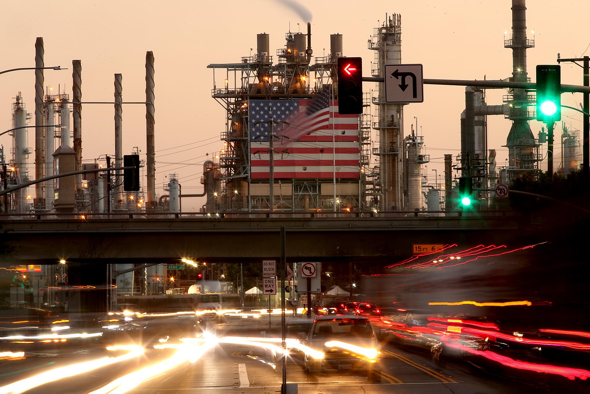 Traffic streams past the Marathon Refinery in Carson. (Luis Sinco / Los Angeles Times)