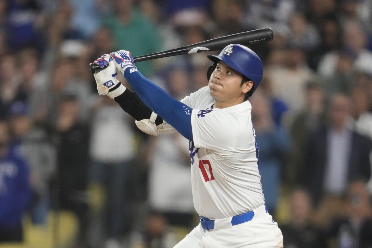 Los Angeles Dodgers' Shohei Ohtani watches his double during the eighth inning.