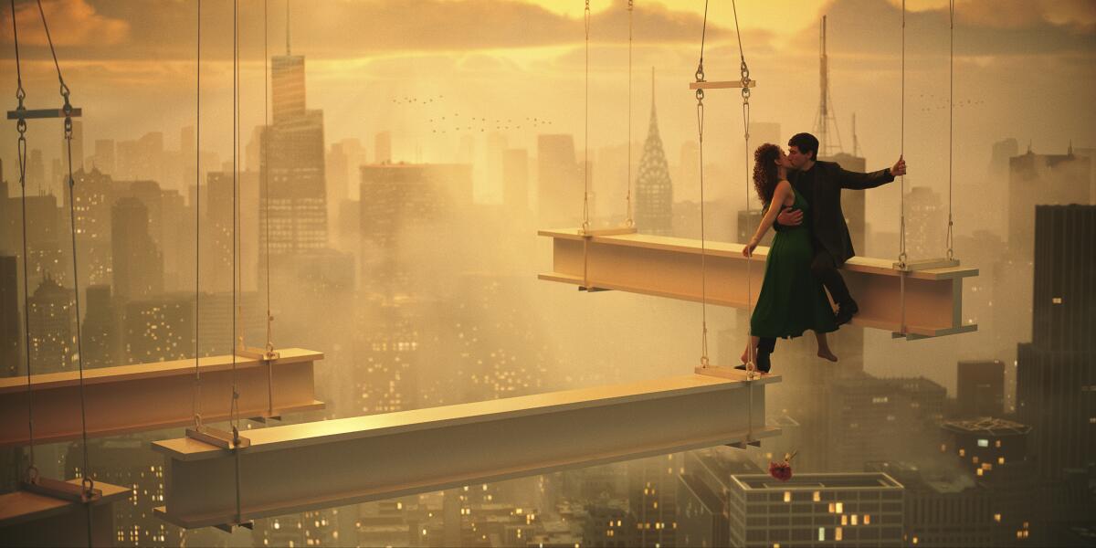 Two people stand on a construction beam.