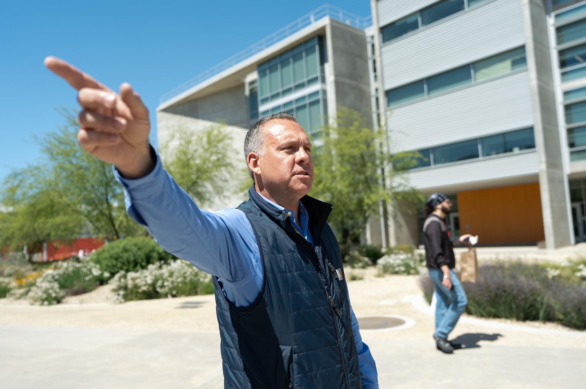 Adam Gray points to land where a new medical school will rise at UC Merced.