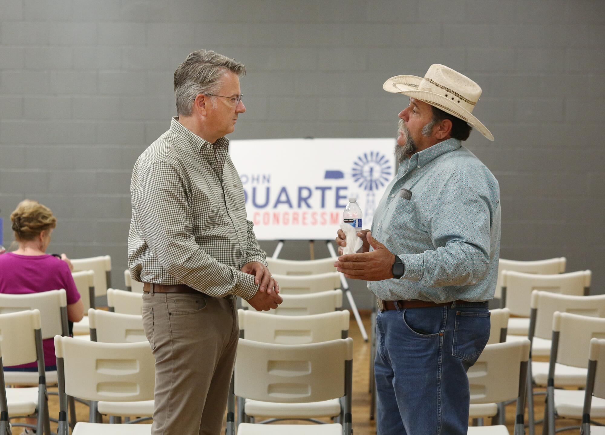 Rep. John Duarte, left, talks to rancher Matt Toste before a town hall meeting in Coalinga.