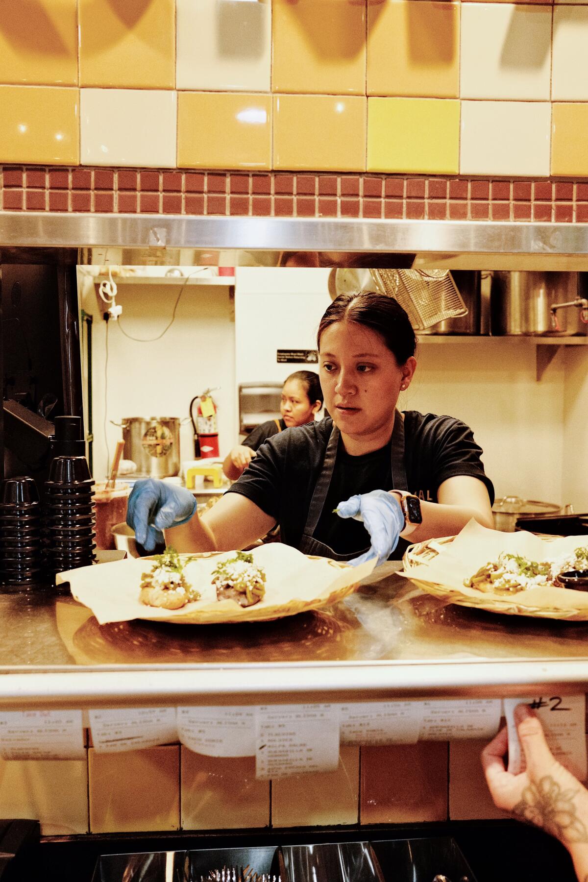 Komal co-owner Fátima Júarez works the line in the kitchen of her combination restaurant and molino.