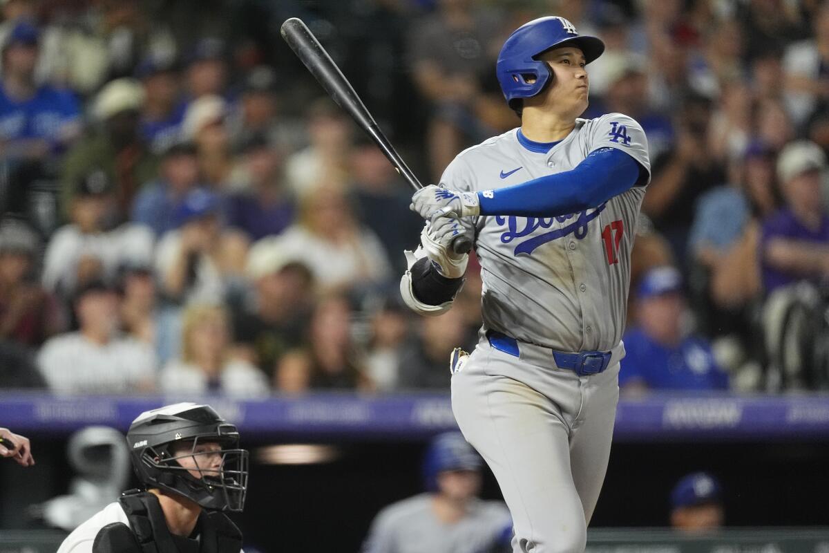 The Dodgers' Shohei Ohtani flies out against the Colorado Rockies in the seventh inning Saturday in Denver.