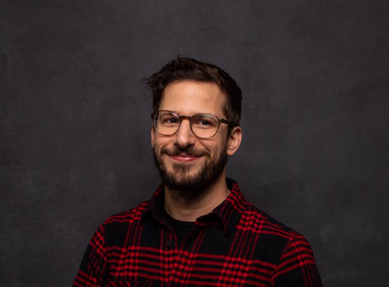 A man in glasses and red and black plaid shirt.