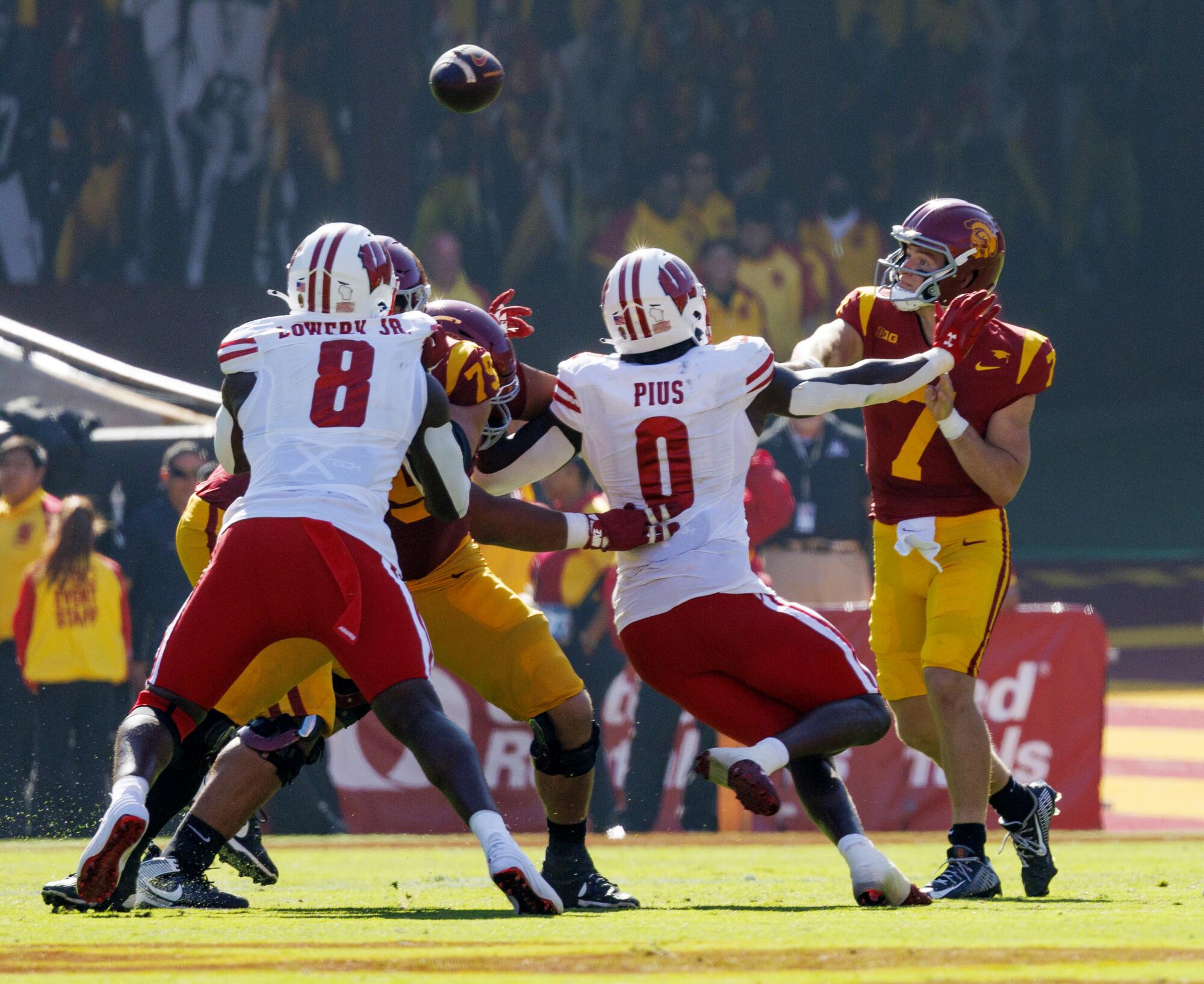 USC quarterback Miller Moss gets a pass off under pressure from Wisconsin's defense at the Coliseum on Saturday.