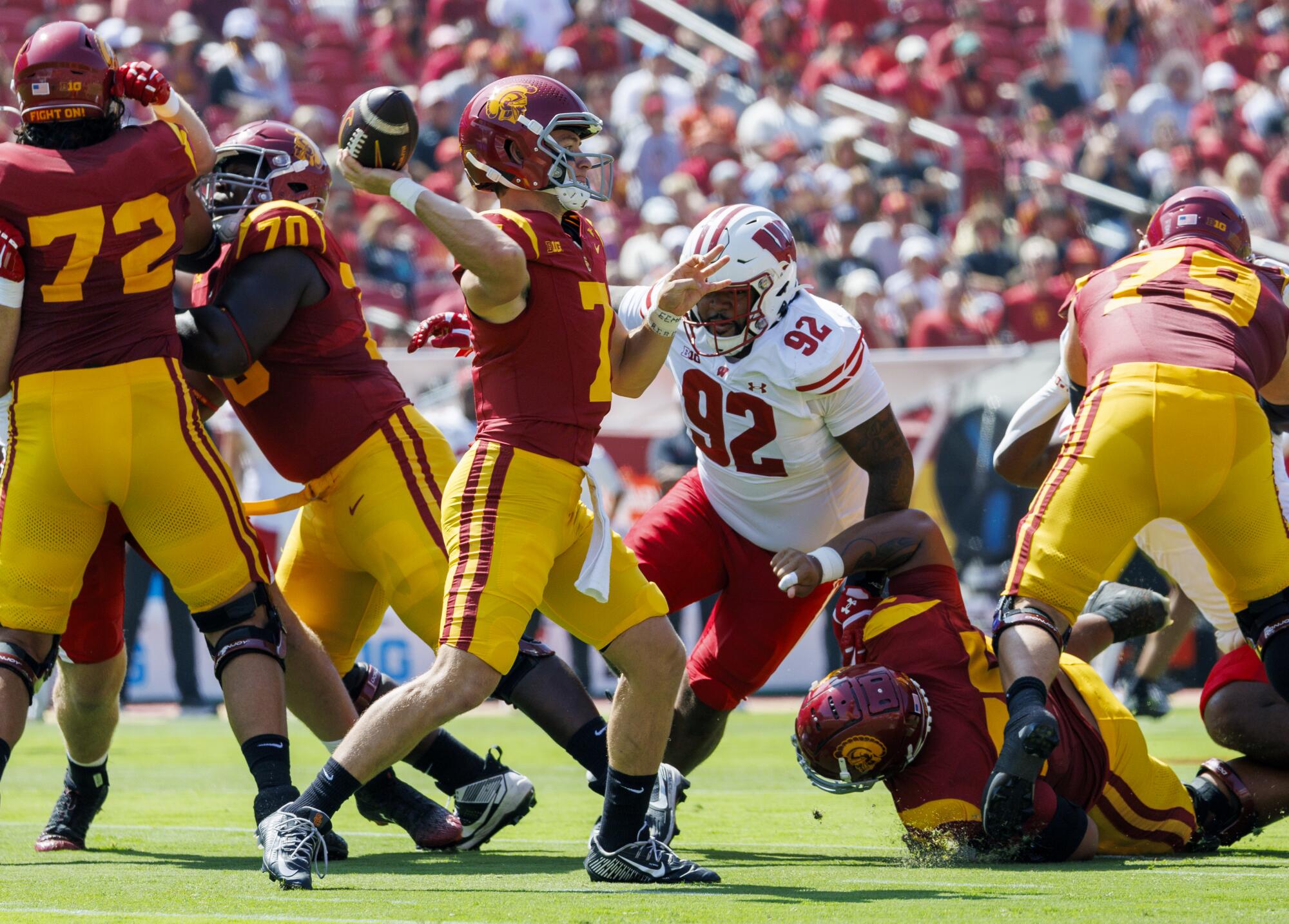 USC quarterback Miller Moss gets his pass off before Wisconsin defensive lineman Curt Neal reaches him Saturday 