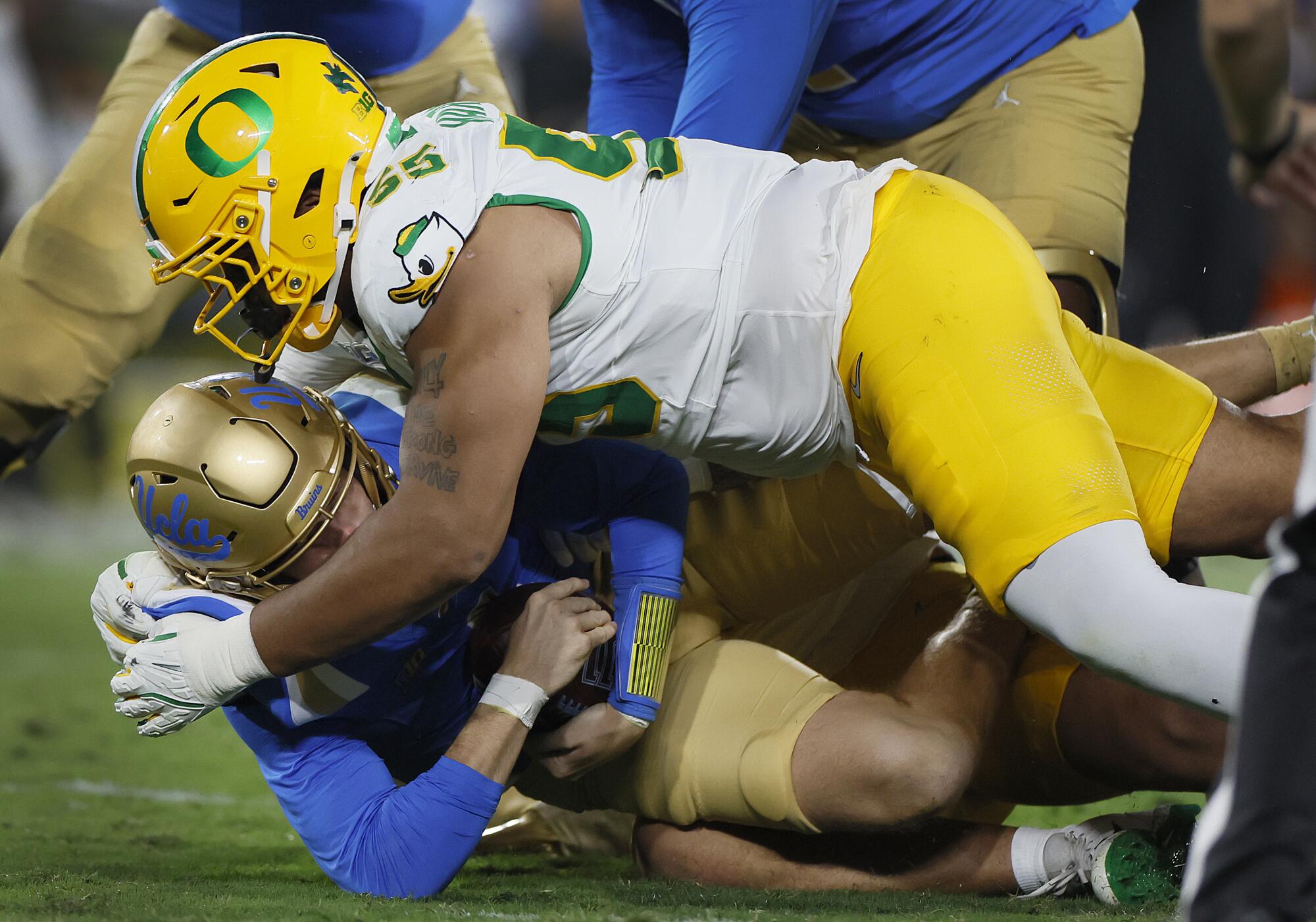 Oregon defensive tackle Derrick Harmon sacks UCLA quarterback Ethan Garbers in the second quarter at the Rose Bowl