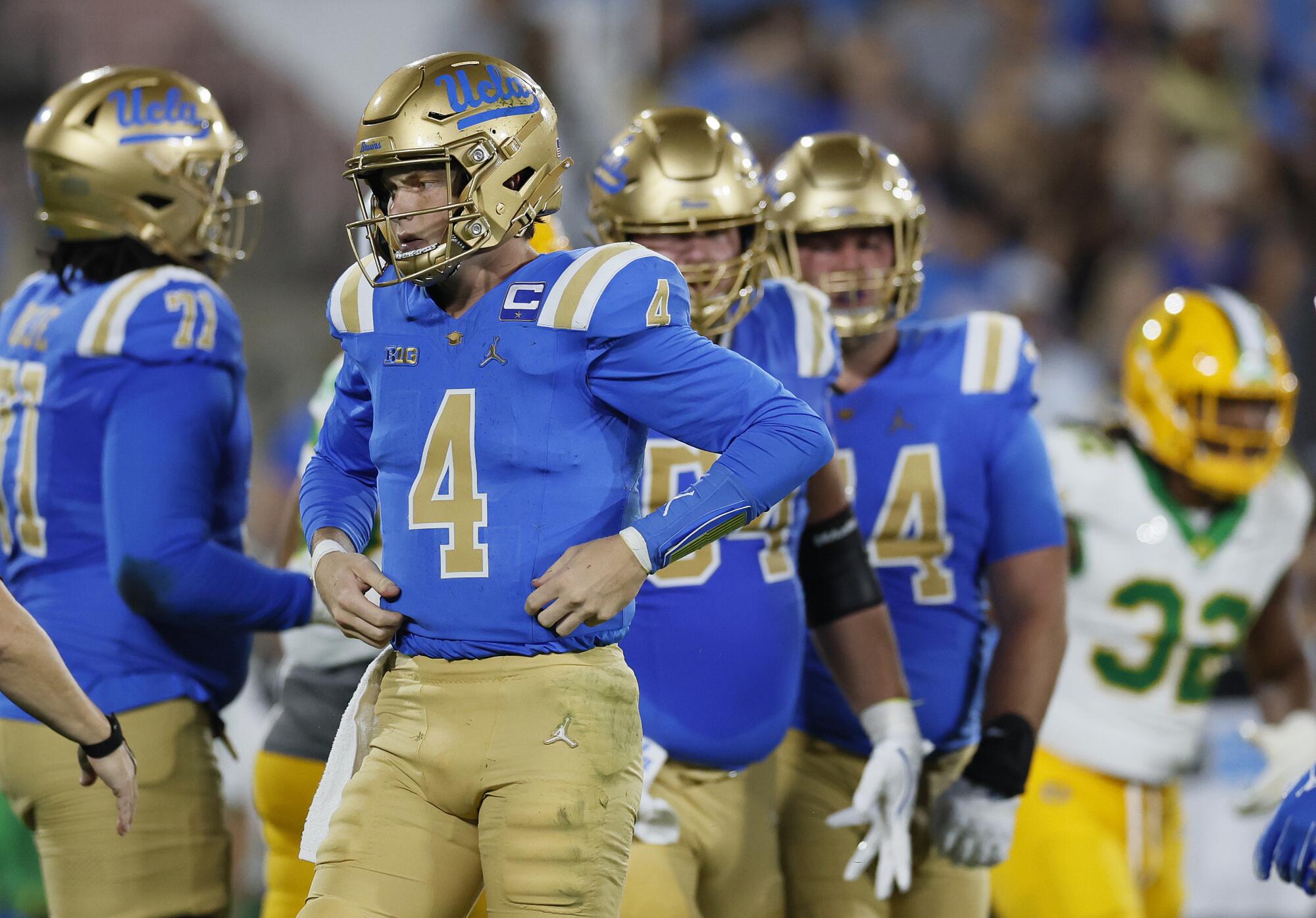 UCLA quarterback Ethan Garbers gets up and recovers after being sacked by the Oregon defense in the second quarter