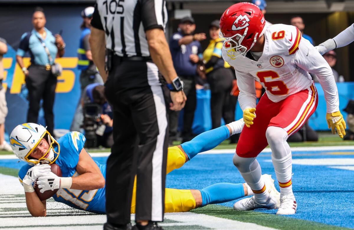 Chargers receiver Ladd McConkey (15) hauls in a touchdown pass in the first half behind Chiefs safety Bryan Cook (6).