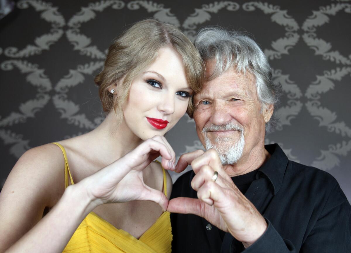 Country singers Taylor Swift and Kris Kristofferson take a photo together.