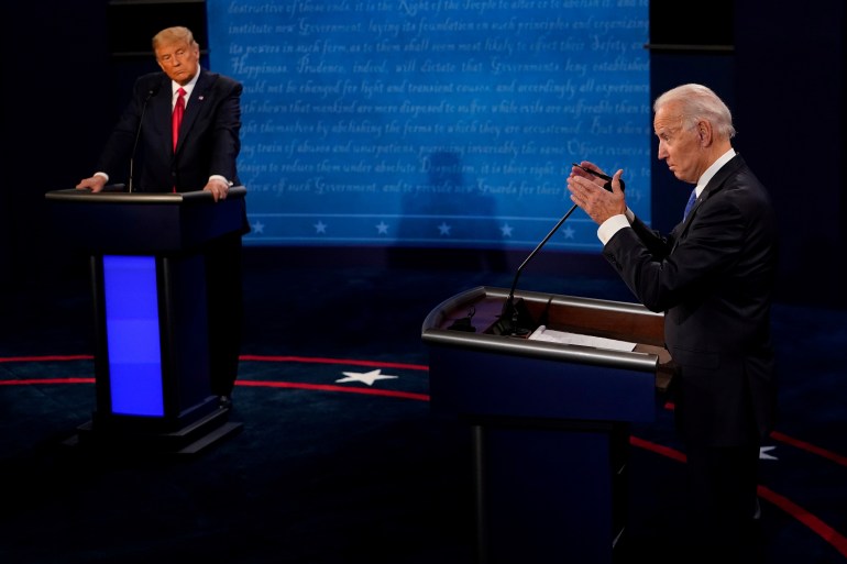 Democratic presidential candidate former Vice President Joe Biden answers a question as President Donald Trump listens during the second and final presidential debate at the Curb Event Center at Belmont University in Nashville, Tennessee, U.S., October 22, 2020. 