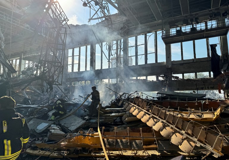 A firefighter amid debris and smoke in a building destroyed in a Russian missile attack