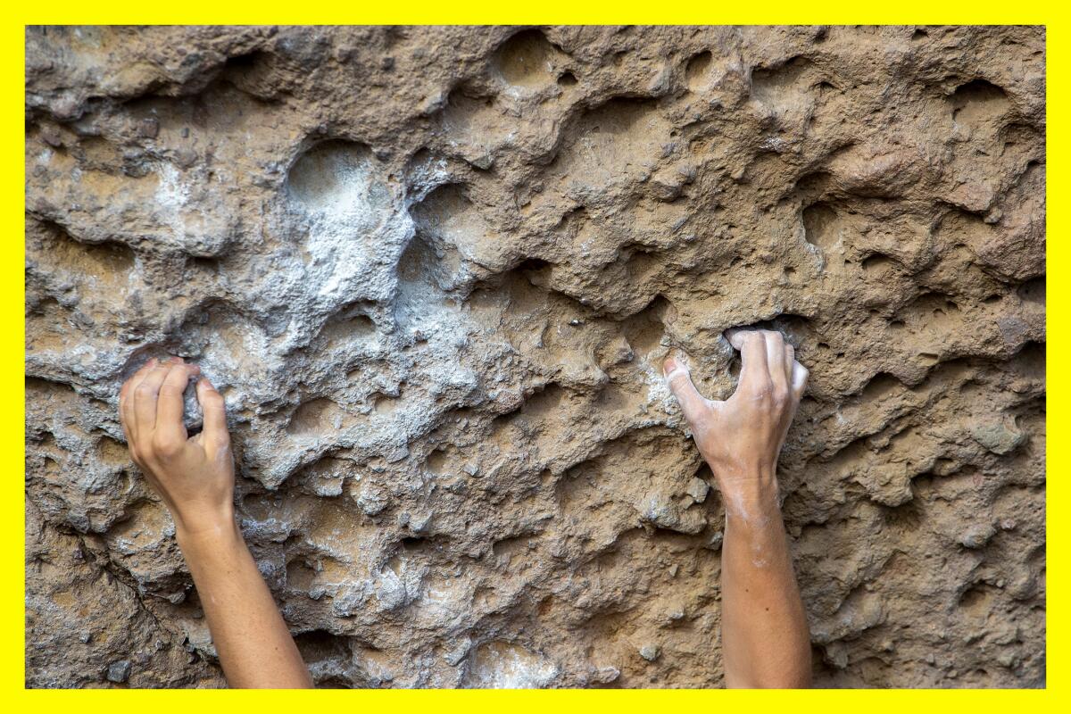 Chalked hands find holds on the rocks in Malibu Creek State Park.