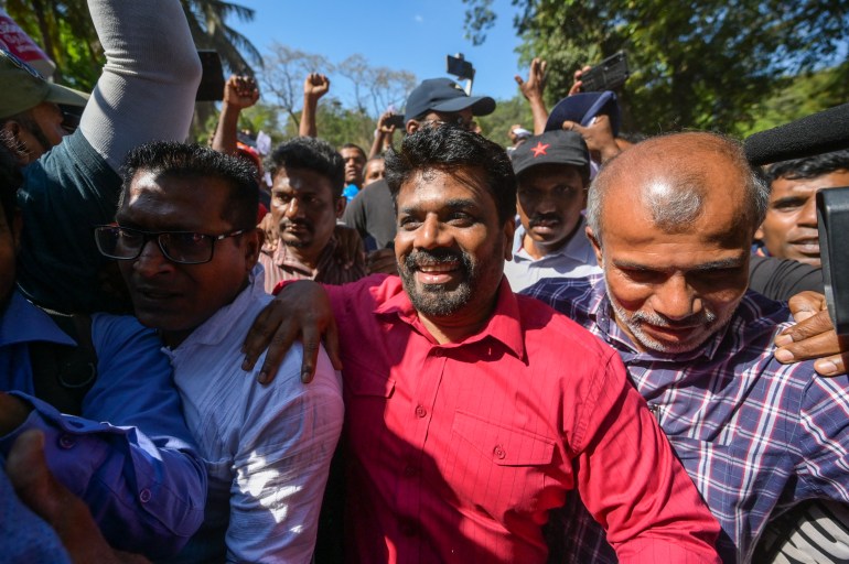 National Peoples Power (NPP) party leader Anura Kumara Dissanayake (C) takes part in a protest held to urge the government to hold local council election as scheduled in Colombo on February 26, 2023. (Photo by ISHARA S. KODIKARA / AFP)