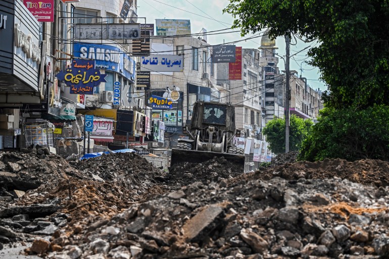 An Israeli bulldozer tears up a street during an Israeli raid in the occupied West Bank city of Jenin on September 1, 2024. (Photo by RONALDO SCHEMIDT / AFP)