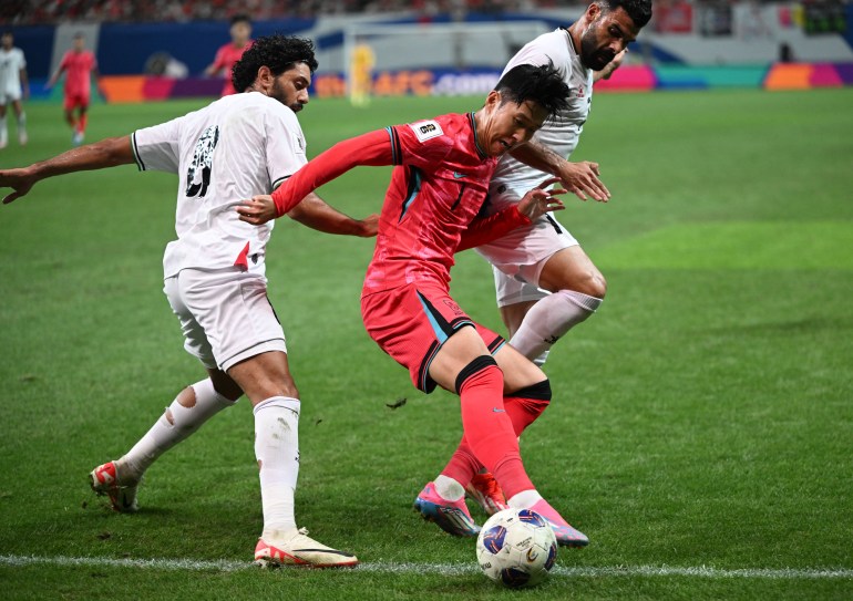 South Korea's Son Heung-min (C) fights for the ball with Palestine's Attaa Jaber (L) and Musab Battat (R) during the FIFA World Cup 2026 Asia zone qualifiers football match between South Korea and Palestine in Seoul on September 5, 2024. (Photo by Jung Yeon-je / AFP)