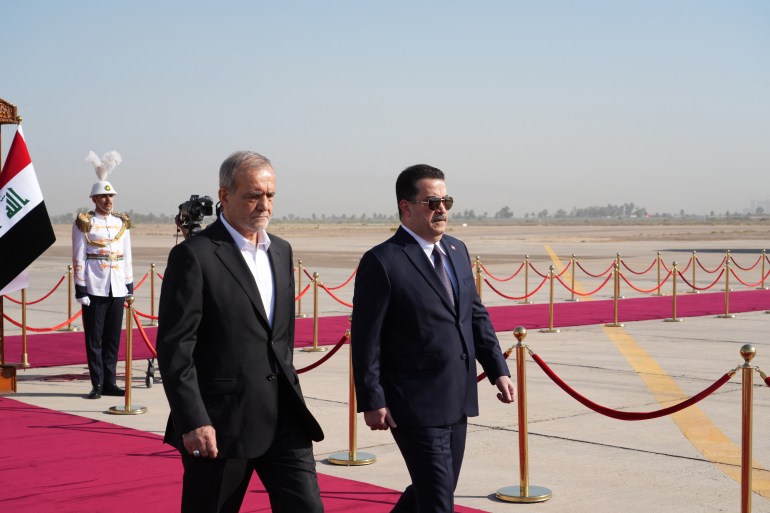 Iraq's Prime Minister Mohamed Shia al-Sudani (R) welcomes Iran's President Masoud Pezeshkian in Baghdad on September 11, 2024. - Pezeshkian arrived in neighbouring Iraq as he moves to deepen already close ties on his first foreign visit since taking office in July 2024. (Photo by Murtada AL-SUDANI / POOL / AFP)