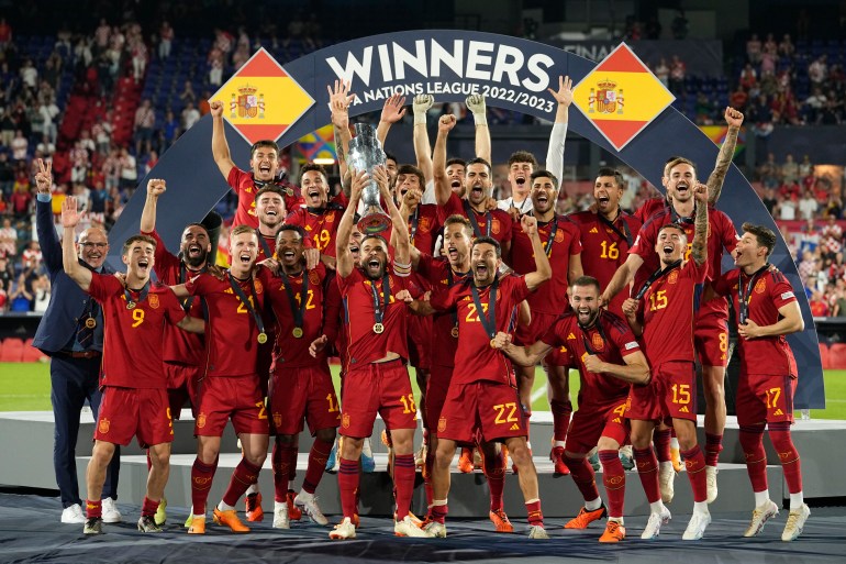 Spain players celebrate with the trophy after winning the Nations League final soccer match between Croatia and Spain at De Kuip stadium in Rotterdam, Netherlands, Sunday, June 18, 2023. (AP Photo/Martin Meissner)