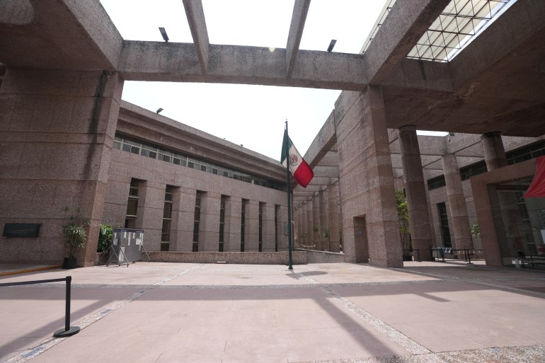 A Mexican flag stands amid the empty corridors of the federal court