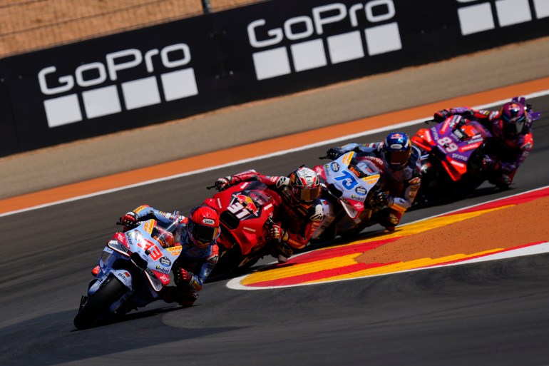 MotoGP riders on track.